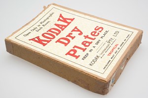 Brown cardboard box with a paper label with red and black text