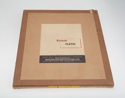 Flat brown box with a plain cream label