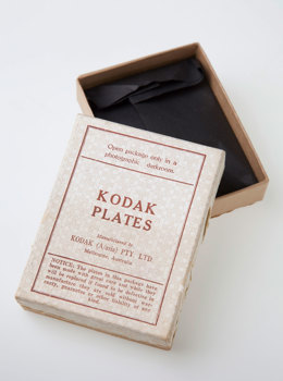 Empty box with the lid ajar reveal the inside. The lid is white with red print.