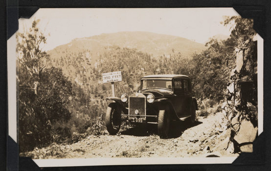 Old style car on a track in the mountains