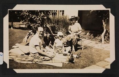 Family sitting on a blanket in a garden