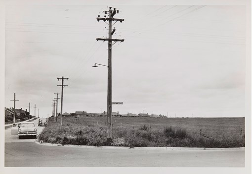 Black and white image of car on country road