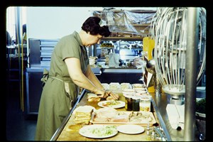Woman preparing food in a commercial kitchen