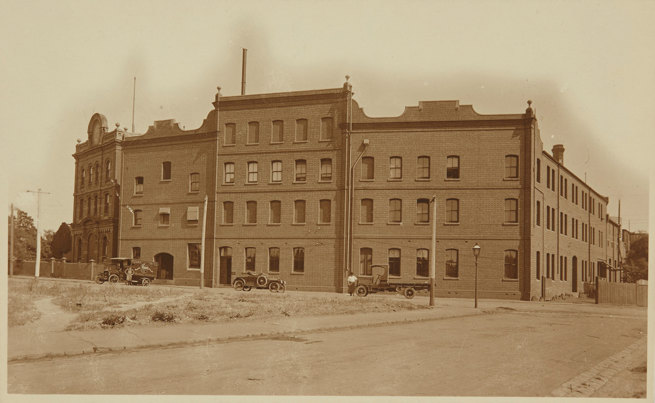 Delivery trucks infront of brick building