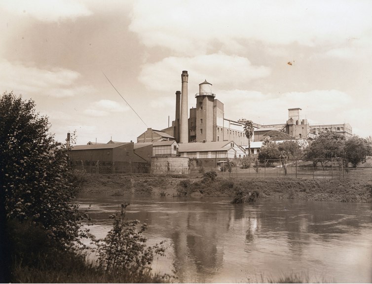 View across river to industrial buildings.