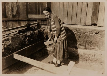 Woman in striped cardigan holding brick