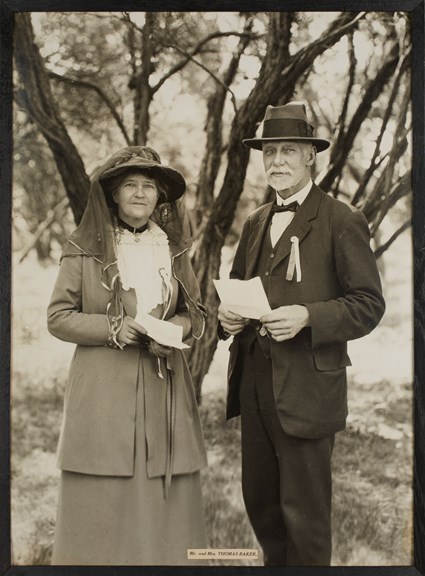 Man and woman standing under tree