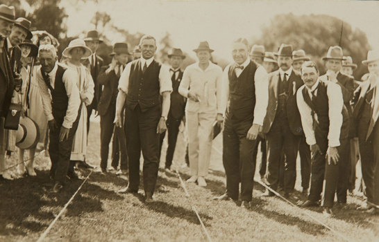 Group of people, with three men in running lanes