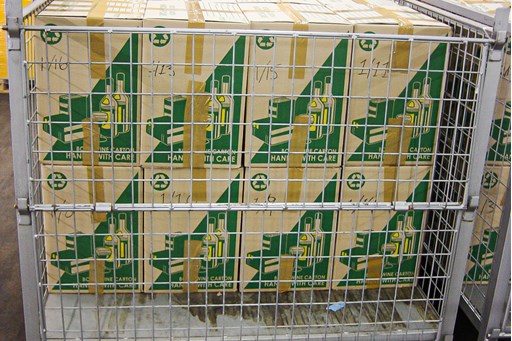 Two rows of packing boxes stacked up in a metal cage