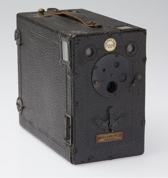 Black box with strap on top and lenses and levers at the front