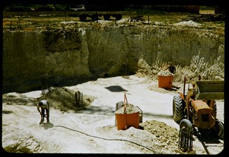 Excavation site with a tractor and a workman