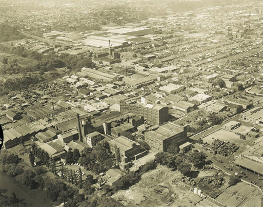 Ariel view of a urban area including factory buildings and river