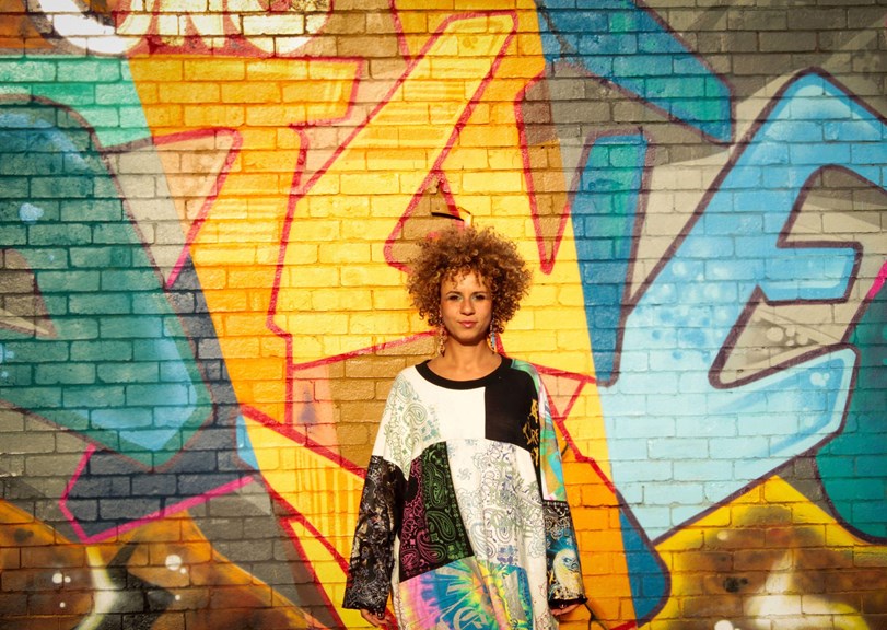 Person standing in front of a graffiti wall