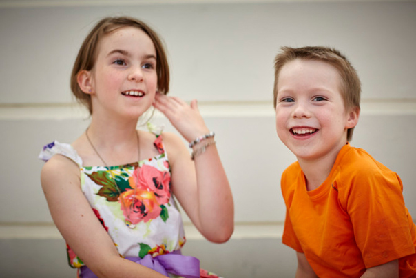 Girl and a boy smiling.