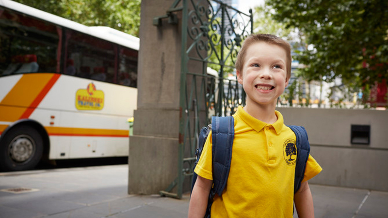 Boy in school uniform visiting Immigration Museum.