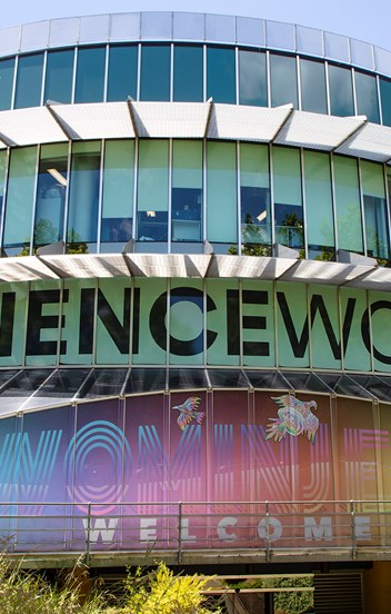 a circular building covered with colourful illustrations and the word Scienceworks
