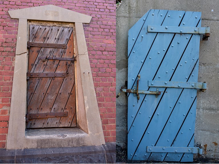 a wooden door inset in a brick wall