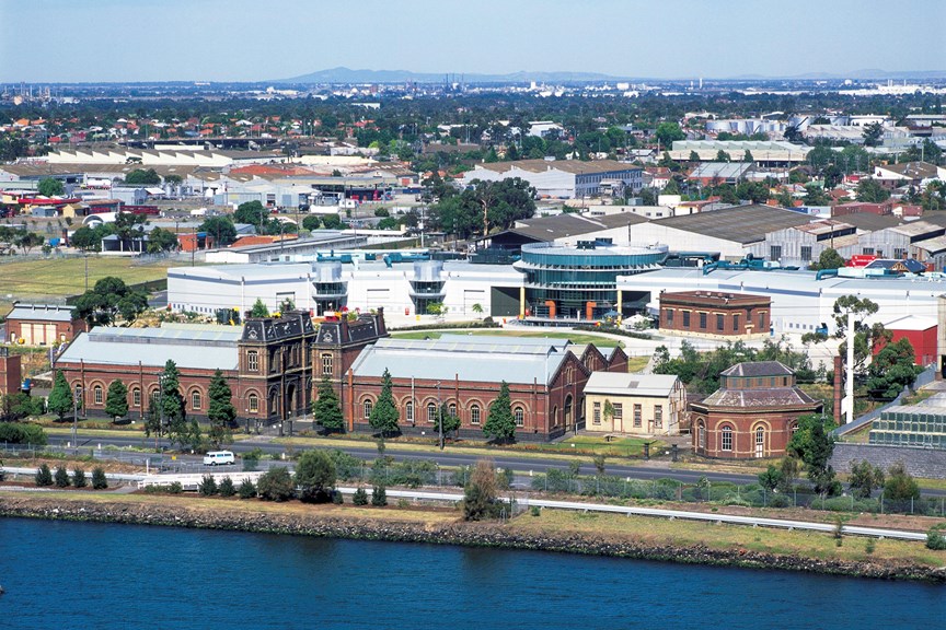 an aerial photograph of industrial buildings next to a river 