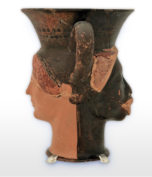 A vase in the shape of two women’s heads, one African