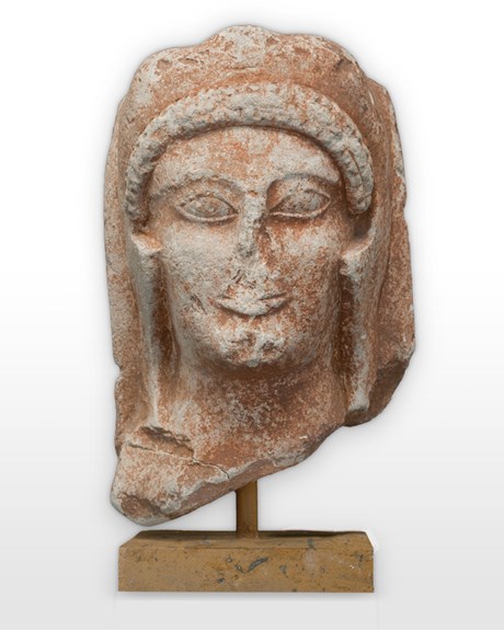 Statue head with worn away facial features