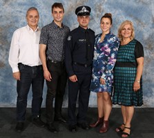 Family stands with one son in police uniform