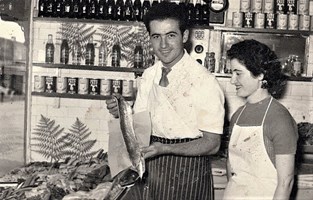 Couple with aprons on in a shop