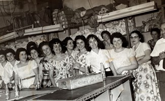 A group of women take a break at a clothing factory