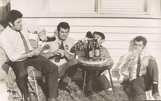 Four men drinking outside.