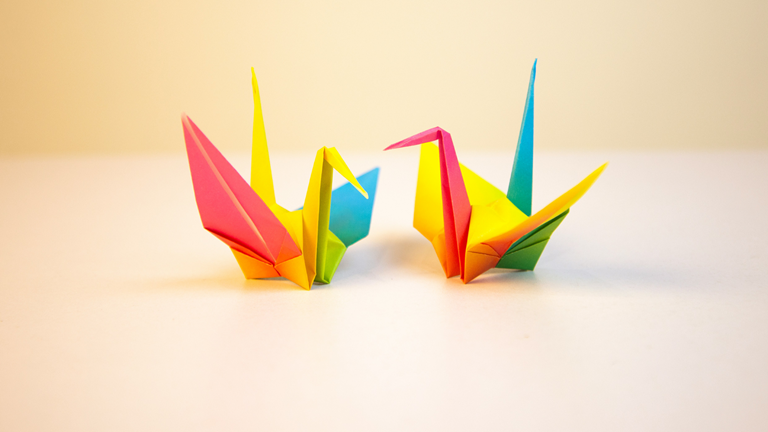 Two technicolour origami peace cranes