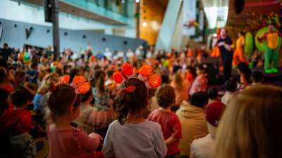 Children watching Emma Memma perform on stage at Melbourne Museum.