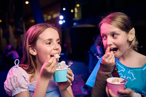 Two girls dressed up eating spooky themed sundaes