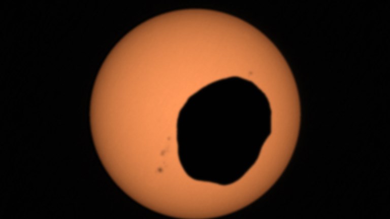Phobos, one of Mars' two moons, eclipsing the Sun