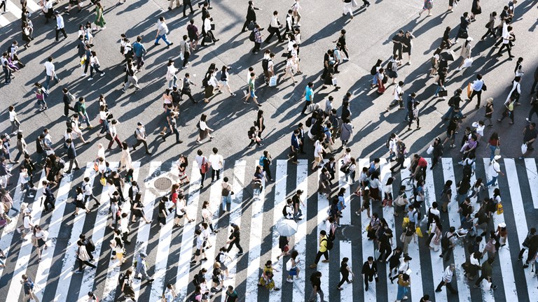 Aerial view of a many people crossing a road