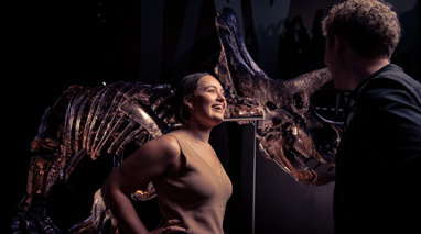 People standing in front of Triceratops