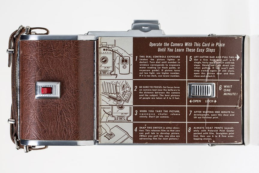 the back of a brown camera with written operating instructions