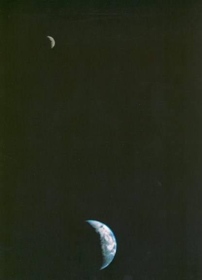 The Moon (close to top left) and the Earth (bottom, centre) in the same photo, both crescent-shaped, separated by starry space