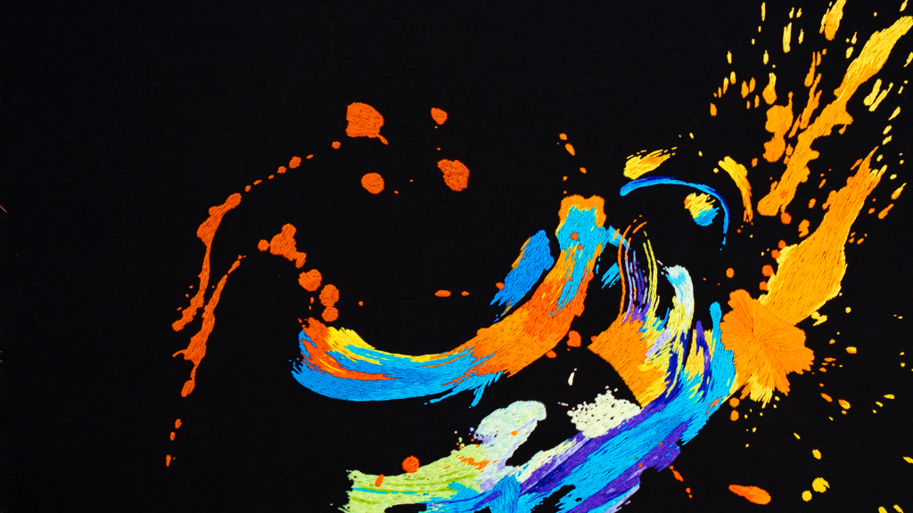 Brightly coloured embroidery on a black background