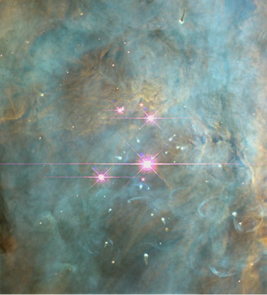 The quartet of young stars making the Trapezium Cluster deep inside the Orion Nebula.