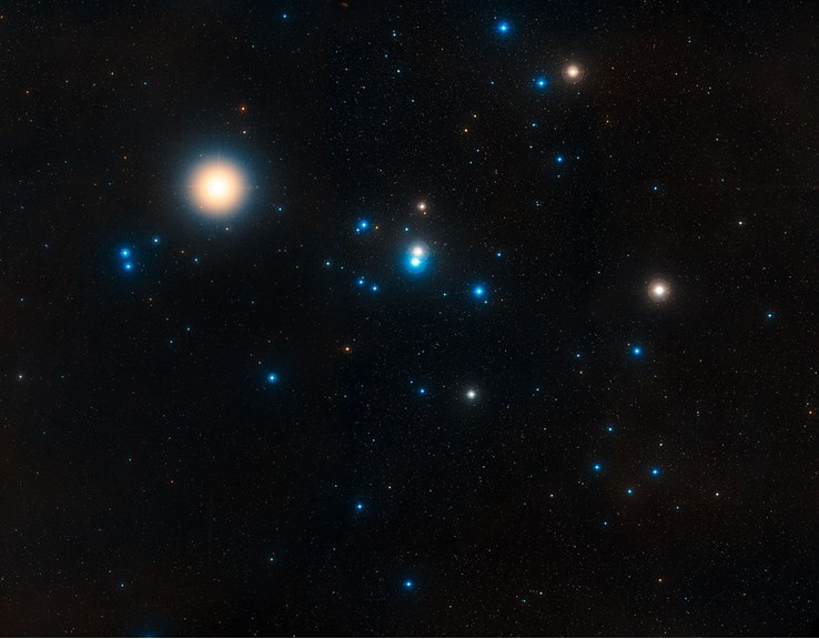 The red giant Aldebaran (upper left) lies in front of the more distant Hyades star cluster in the constellation of Taurus. 
