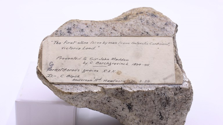 A speckled rock featuring a hand written label