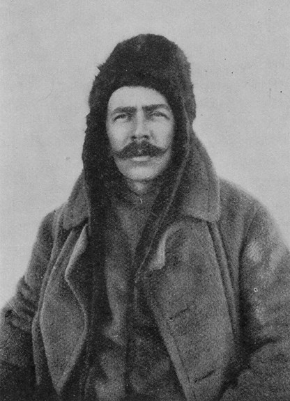 a black and white photo of a moustached man wearing furs