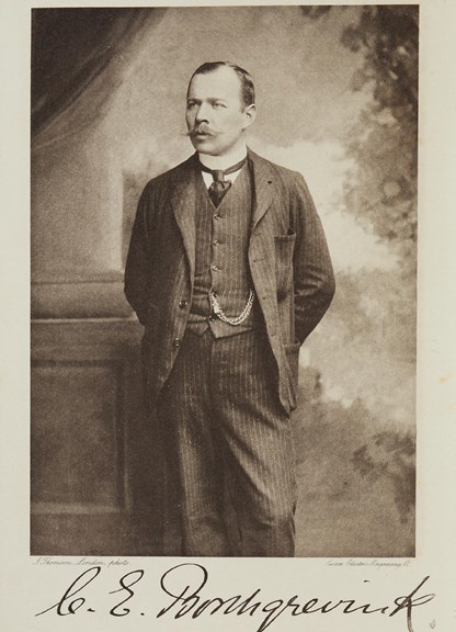 an autographed black and white  image of a man in a suit