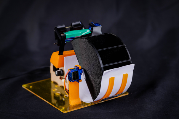 A system comprised of curved, coloured components, affixed to a yellow perspex square.