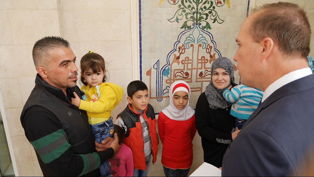 Marwan Alkhdah and family from Syria receive refugee visas from Immigration Minister Peter Dutton, 2015. 