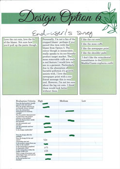 A close up photograph of the final product, showing the bottom of wide trouser legs. The trousers are olive green and have knitted daisies attached.