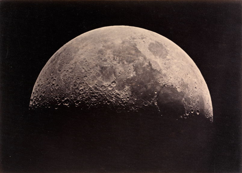 Image of the Moon with shadow on its lower half. It is surrounded by darkness.