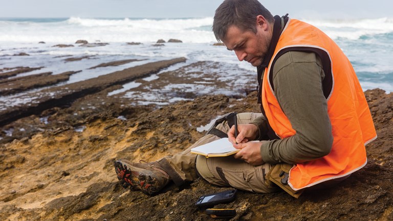 Museums Victoria staff member, Erich Fitzgerald writing notes in the field, Otways Bioscan.