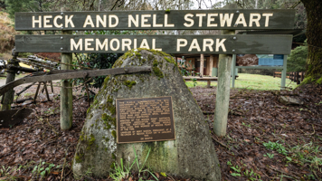 A wooden sign reads "Heck and Nell Stewart Memorial Park". 