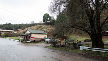 An old fashioned general store and post office stands by the reserve where the plaque commemorates the destruction of the town.