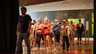 Primary school students entering First People exhibition for the 'Our Shared History' program.